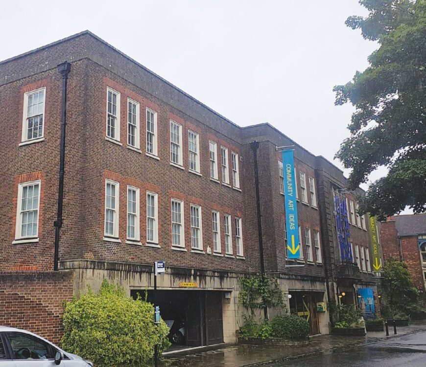Charleston in Lewes, an Art Gallery. large brown building with colourful banners